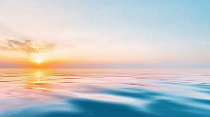 Obraz premium Vibrant hues of orange, pink, and purple fill the sky at sunset, reflecting on calm ocean waves. Gentle ripples create a serene atmosphere as clouds enhance the peaceful view