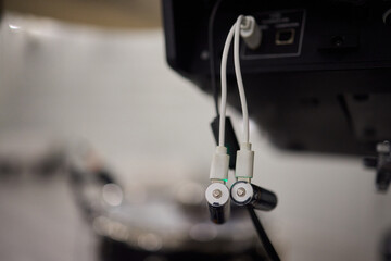 A detailed closeup of audio equipment that is being connected to drums for a performance