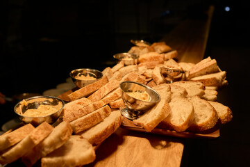 A beautifully arranged Assorted Bread Platter featuring a variety of Spreads on a Wooden Countertop