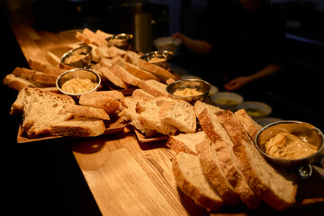 A beautifully arranged Assorted Bread Platter featuring a variety of Spreads on a Wooden Countertop