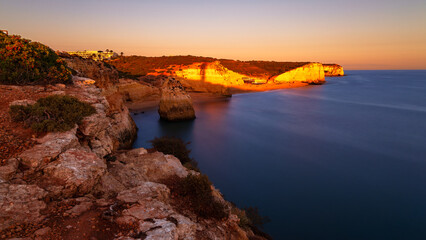 Costa Sudoeste National Park on the Algarve coast of Portugal. Sunset on the rocky coast near Portimao. The golden hour.