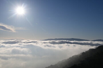 beautiful sunrise in the mountains over the fog and clouds