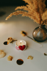 decorative candle with hearts is burning