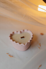 pink heart-shaped candle on a white background
