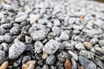 Bed of pebbles or smooth rocks and stones with light gray texture