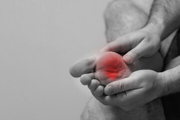 A man experiences pain after long walks, sports, wearing uncomfortable shoes or insufficient foot...