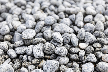 Bed of pebbles or smooth rocks and stones with light gray texture
