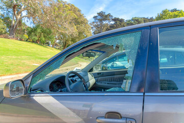 SAN FRANCISCO, CALIFORNIA - CIRCA OCTOBER, 2021: Close up view of the broken glass window of a car because of theft crime