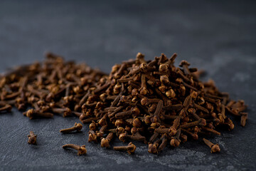 cloves spice on a black kitchen table, selective focus.