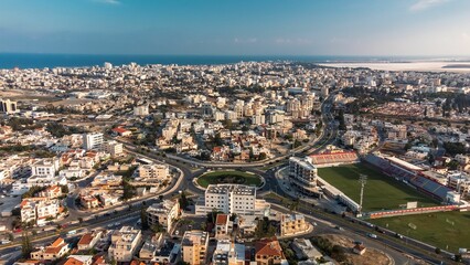 Obraz premium Aerial view of Larnaca, Cyprus, showcasing the cityscape, coastline, and a football stadium.