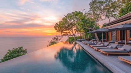 A five-star hotel infinity pool reflecting golden hues of the sunset, with sunbeds aligned along the deck.