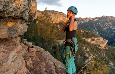 Outdoor sport activity. Rock climber on a belay in beautiful rock area. Active leisure. Margalef, Spain.