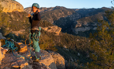 Outdoor sport activity. Rock climber on a belay in beautiful rock area. Active leisure. Margalef,...