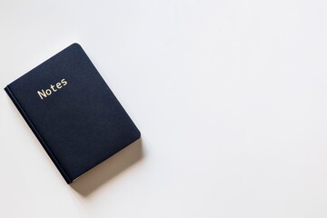 Exploring creativity during quiet moments with a simple notes book resting on a clean surface. Generative AI