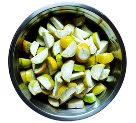 Ripe and crude scarlet eggplant aslo known as jiló or jilo in brazil, chopped in the stainless steel bowl. Typical brazilian recipe.