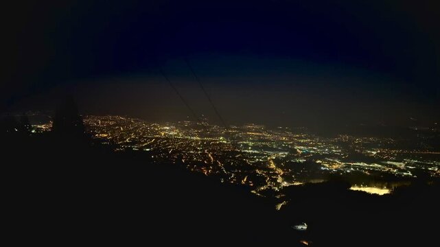 View of the night winter city from the top of the mountain. High quality 4k footage