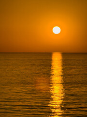 Ionian Sea, East of Sicily, Italy - July 5, 2024: Sunrise colors sky and sea orange