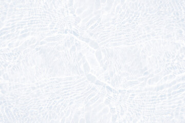 White water with ripples on the surface. Defocus blurred transparent white colored clear calm water surface texture with splashes and bubbles. Water waves with shining pattern texture background.