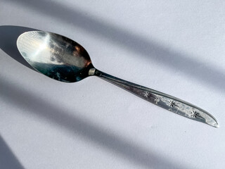 The spoon, their smooth lines clearly displayed on the white canvas