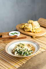 Pecel. Traditional Javanese vegetable salad with sweet and spicy peanut sauce; served with white rice, fried tempeh, and stuffed fried tofu.