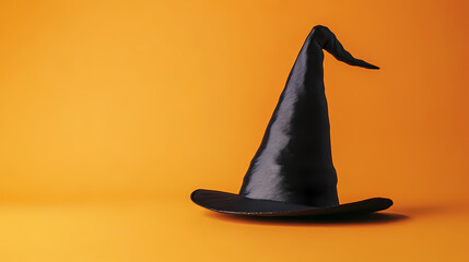 Fototapeta premium Black wizard hat on orange background