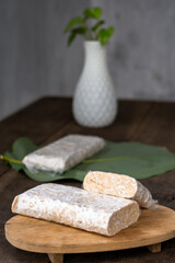 Raw Tempeh Slices on Wooden Board Background. Tempeh is Made from Fermented Soybeans