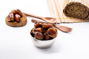 Delicious dried dates, popular fruit dates during the month of Ramadan in a silver bowl