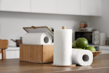 Box with rolls of paper napkins on table in kitchen, closeup