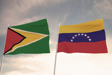 Relations between Venezuela and Guyana symbolized by two flags waving against a cloudy sky, highlighting the Essequibo dispute. 3D render.
