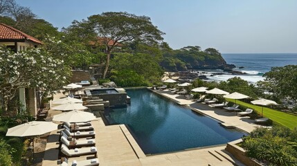 Tranquil Oceanfront Resort Pool Surrounded by Lush Greenery