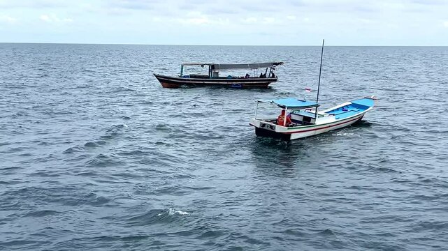 View of traditional wooden fishing boats used by Indonesian fishermen to catch fish in the Java Sea of Indonesia