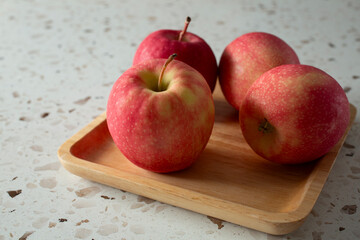 A view of some pink lady apples on a plate.