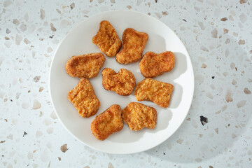 A top down view of restaurant style chicken nuggets.