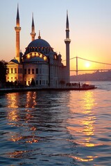 Fototapeta premium Illuminated mosque at sunset, reflecting in calm water with bridge in background.