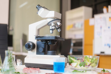 A food scientist analyzes food samples, plants, vegetables, and meat using a microscope and laboratory equipment to ensure safety, quality, and innovation in food science and technology