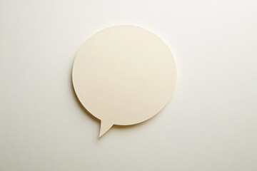 An isolated beige speech bubble placed on a white surface