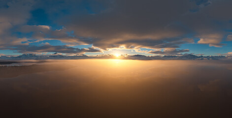 Panoramic View of a Stunning Sunset Over a Snowy Mountain Range