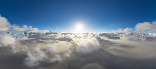 Breathtaking Aerial View of Mountain Peaks Above the Clouds at Sunrise