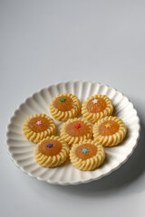 Pineapple Tart or Tart Nenas, a popular cookie in Malaysia during celebration of Eid Mubarak (Hari Raya) isolated on white background with some shadow and selective focus.