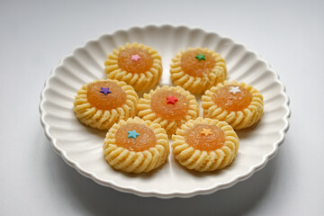 Pineapple Tart or Tart Nenas, a popular cookie in Malaysia during celebration of Eid Mubarak (Hari Raya) isolated on white background with some shadow and selective focus.