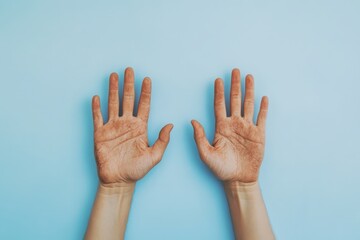 Obraz premium Two human hands showing dirt against a simple blue background