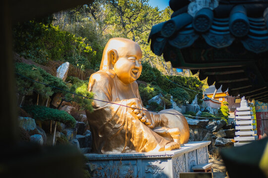 Smiling Buddha Haedong Yonggungsa Temple Busan,Korea September &lrm;24, 2023: Smiling Buddha in Haedong Yonggungsa Temple  
Glittering gold color.
