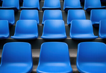 Fototapeta premium Blue stadium seats arranged in rows create vibrant and inviting atmosphere for spectators. uniformity of seating enhances visual appeal of venue