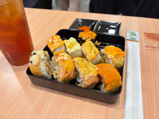 dinner with sushi variants, and fresh iced tea ready to enjoy