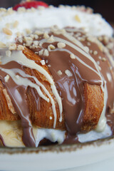 Delicious dessert featuring croissant topped with chocolate and nuts