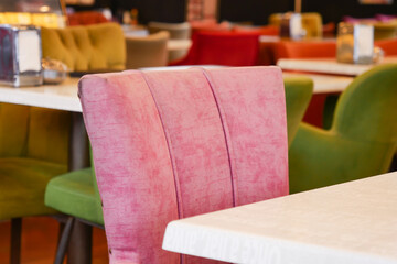 Colorful dining chairs arranged in a bright restaurant interior