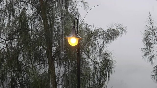 light bulb on lamp post with foggy mountain background, calm and fresh outdoor atmosphere concept