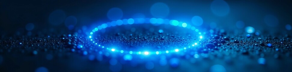 Close up of radiant blue circular light on dark surface, mysterious ambiance, surreal, modern