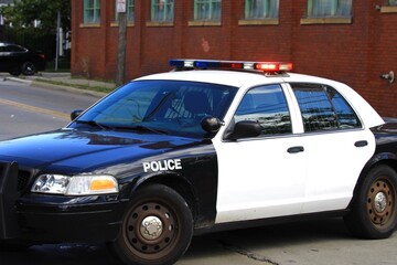 Police car blocking the road near the crime scene