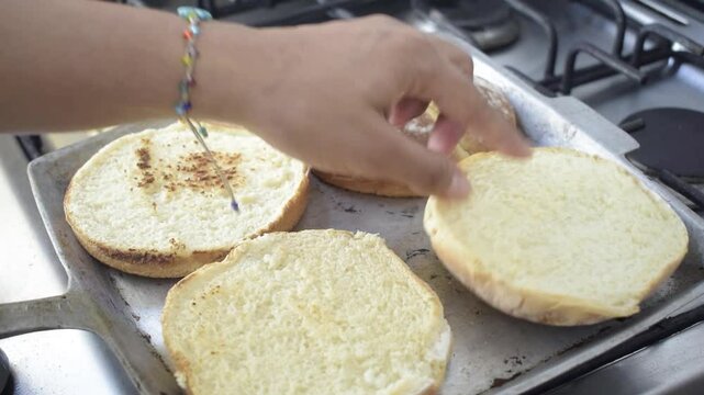 Latin American woman toasting bread on homemade comal